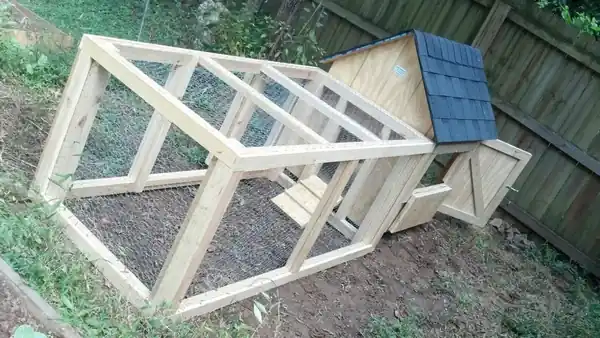 A coop with its run frame standing beside it