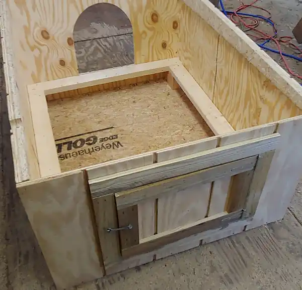 Inside a finished Clark's house: the floor board and a framed door, showing how it is put together